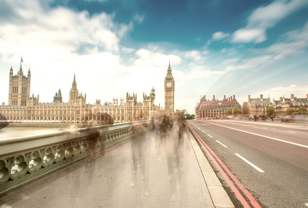 London. Blurred moving people along Westminster Bridge on a sunn