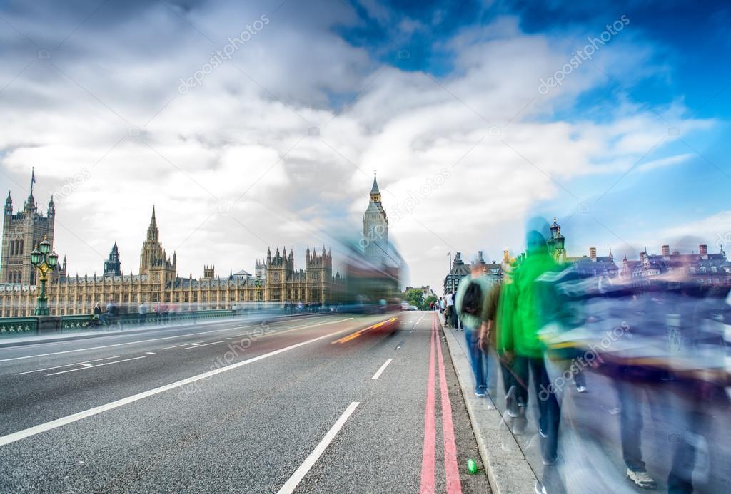 London. Blurred moving people along Westminster Bridge on a sunn