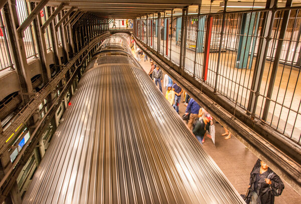 NEW YORK CITY - JUNE 14, 2013: Tourists and commuters wait for a