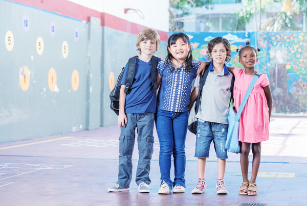Schoolchildren embracing happy. Multi cultural racial classroom