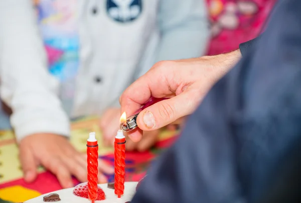 Lighting the candles on a birthday cake — Stock Photo, Image