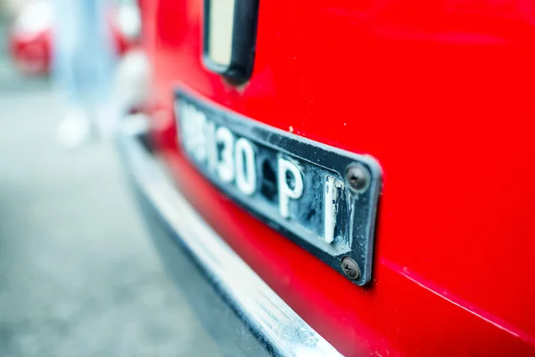 Old red Fiat 500 along city streets. — Stock fotografie