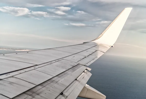 Airplane wing in sky