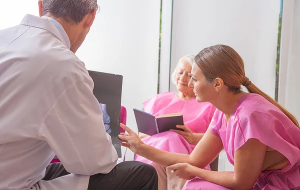 Doctors analyzing results with patient — Stock Photo, Image