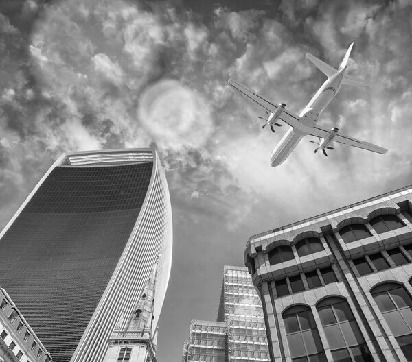 Airplane landing in London, UK. Tourism concept. Black and white