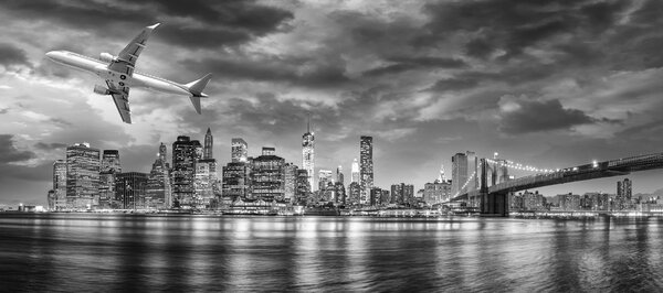 Black and white view of airplane overflying New York City.