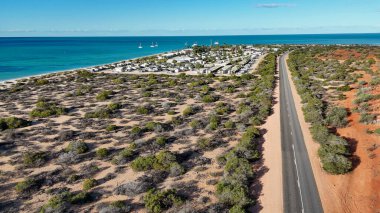 Aerial drone view of Monkey Mia coastline Western Australia with turquoise waters and sandy beaches.