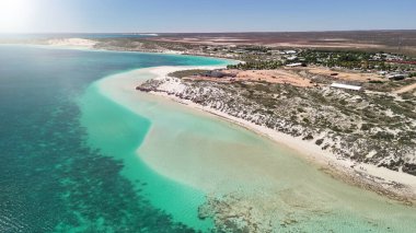 Coral Bay kıyı şeridinin insansız hava görüntüsü temiz mavi suları ve WA 'daki kumlu sahili gösteriyor..