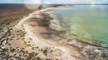 Aerial drone view of Hamelin Pool in Western Australia showing stromatolites and turquoise waters.
