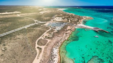 Coral Bay kıyı şeridinin insansız hava görüntüsü temiz mavi suları ve WA 'daki kumlu sahili gösteriyor..