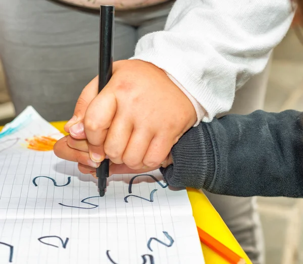 Children hands writing together — Stock Photo, Image