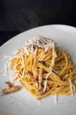 Hands preparing fresh Italian pasta dough with traditional ingredients at home kitchen.