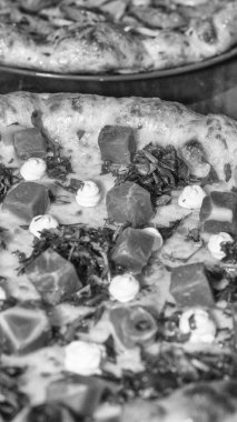 Monokrom pizza görüntüsü desen, malzemeler ve zanaatkar pişirme tarzını detaylı olarak gösteriyor..