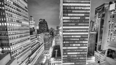 Manhattan hava trafiği geceleyin yüksek gökdelenlerin ortasında.