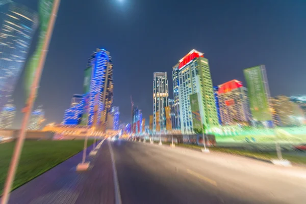 Blurred view of Dubai buildings at dusk