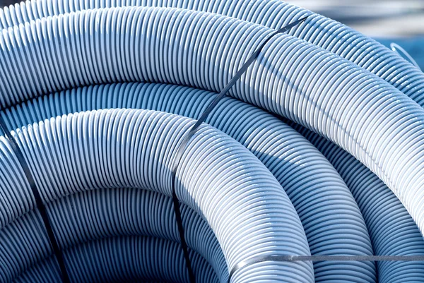 Grey plastic corrugated pipe in industrial site