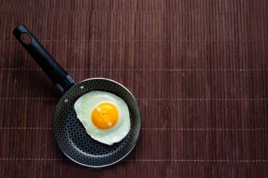 Bambu masasında kızarmış yumurtalı tava..