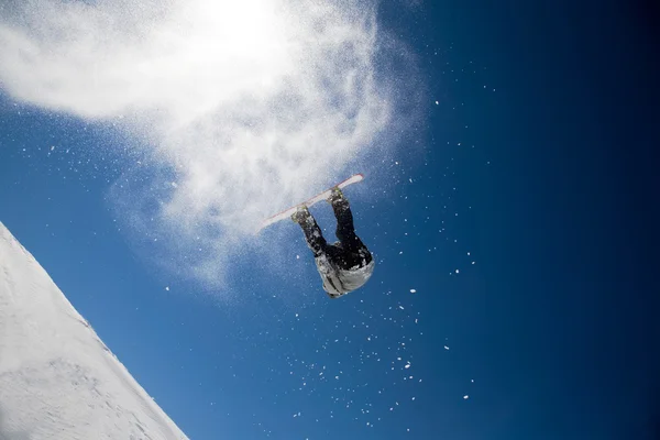 Snowboarder launching off a jump — Stock Photo, Image