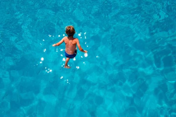 Boy jumping into sea water — Stock Photo, Image