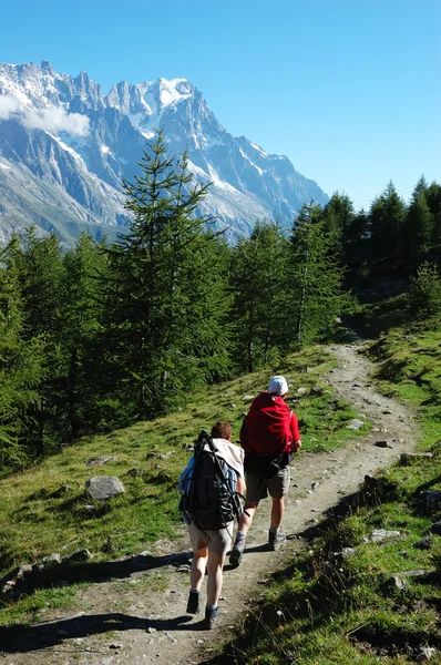 Trekkers walking along a mountain path Stock Picture