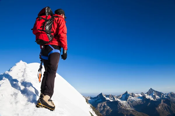 Einsamer Bergsteiger erreicht Gipfel Stockfoto