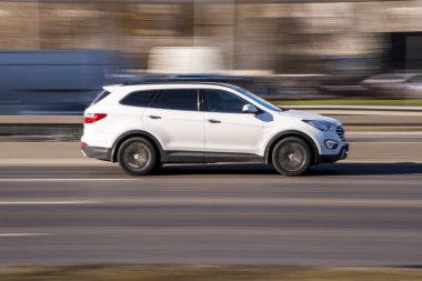 Ukraine, Kyiv - 3 March 2021: White Hyundai Santa Fe car moving on the street; clipart