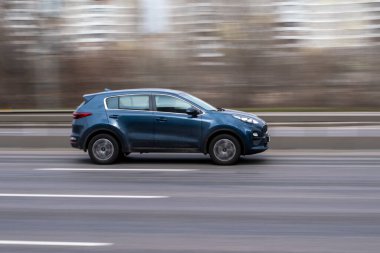 Ukrayna, Kyiv - 18 Mart 2021: Mavi KIA Spor arabası sokakta hareket ediyor. 