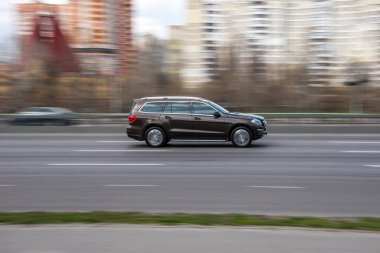 Ukrayna, Kyiv - 6 Nisan 2021: Kahverengi Mercedes-Benz GL-klasse AMG arabası yolda ilerliyor. 