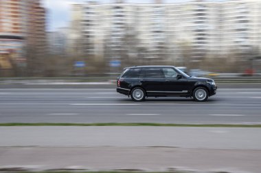 Ukrayna, Kyiv - 6 Nisan 2021: Siyah araba sokakta hareket ediyor.  