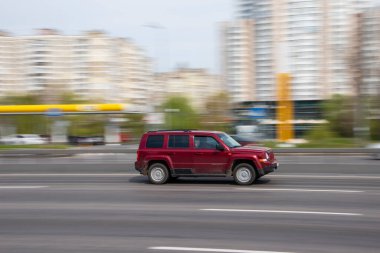 Ukraine, Kyiv - 30 April 2021: Red Jeep Patriot car moving on the street. Editorial