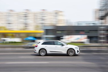 Ukraine, Kyiv - 30 April 2021: White Audi e-tron car moving on the street. Editorial