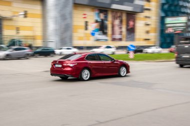 Ukrayna, Kyiv - 26 Nisan 2021: Kırmızı Toyota Camry arabası yolda ilerliyor.  