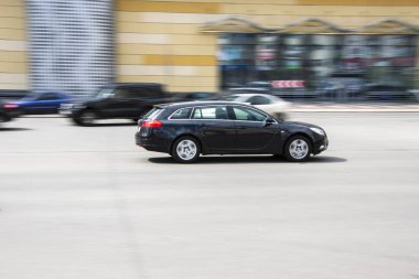 Ukraine, Kyiv - 26 April 2021: Black Opel Insignia car moving on the street. 