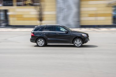 Ukraine, Kyiv - 26 April 2021: Black Mercedes-Benz M-klasse car moving on the street. 