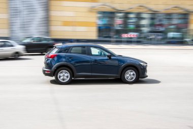 Ukraine, Kyiv - 26 April 2021: Blue MAZDA CX-3 car moving on the street. 