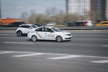 Ukraine, Kyiv - 29 April 2021: White Skoda Rapid  Patrol Policecar moving on the street. Editorial