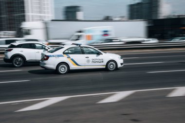 Ukraine, Kyiv - 29 April 2021: White Skoda Rapid  Patrol Policecar moving on the street. Editorial
