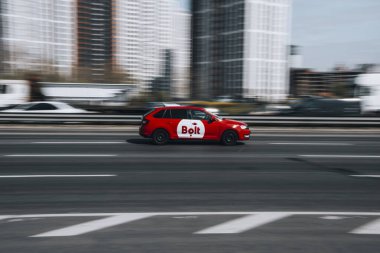 Ukraine, Kyiv - 29 April 2021: Red Bolt Taxi car moving on the street. Editorial