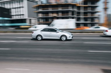 Ukrayna, Kyiv - 29 Nisan 2021: Beyaz Toyota Camry arabası yolda ilerliyor. 
