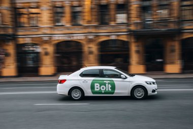 Ukraine, Kyiv - 2 June 2021: White Lifan Murman Taxi Bolt car moving on the street.  clipart