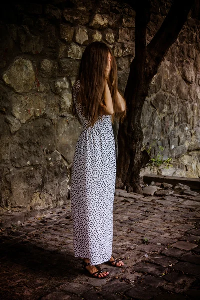 Pleurer jeune femme solitaire près du mur — Photo