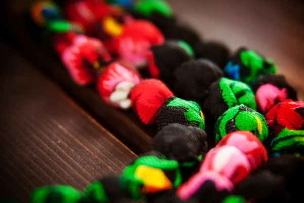 Fragment of a fabric necklace of colourful flowers with the meta — Stock Photo, Image