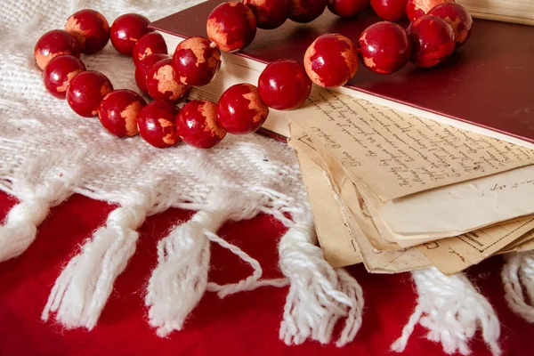 old letters, book and wooden beams on fabric background