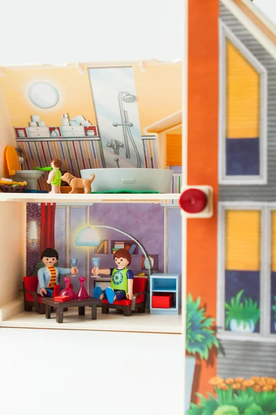 Plastic doll house with a doll family inside