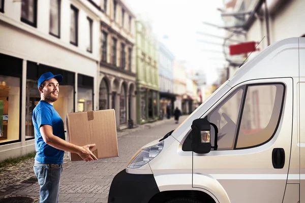 Man with box next to delivery truck — Stock Photo, Image