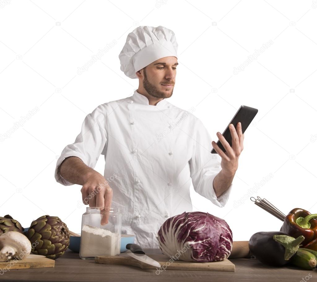 Chef reads a recipe from the tablet.