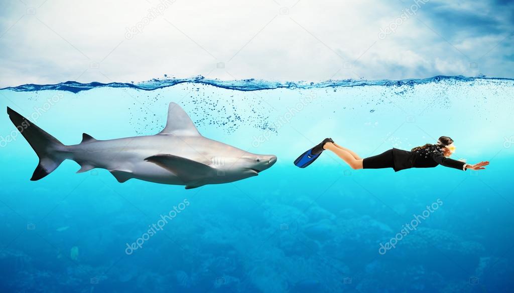 Shark swims behind a businesswoman