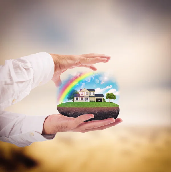 Man holding house in his hands — Stock Photo, Image