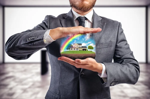 Businessman holding house in his hands — Stock Photo, Image