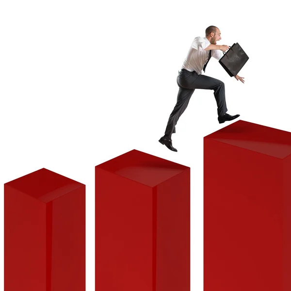 Businessman runs and jumps on statistic — Stock Photo, Image